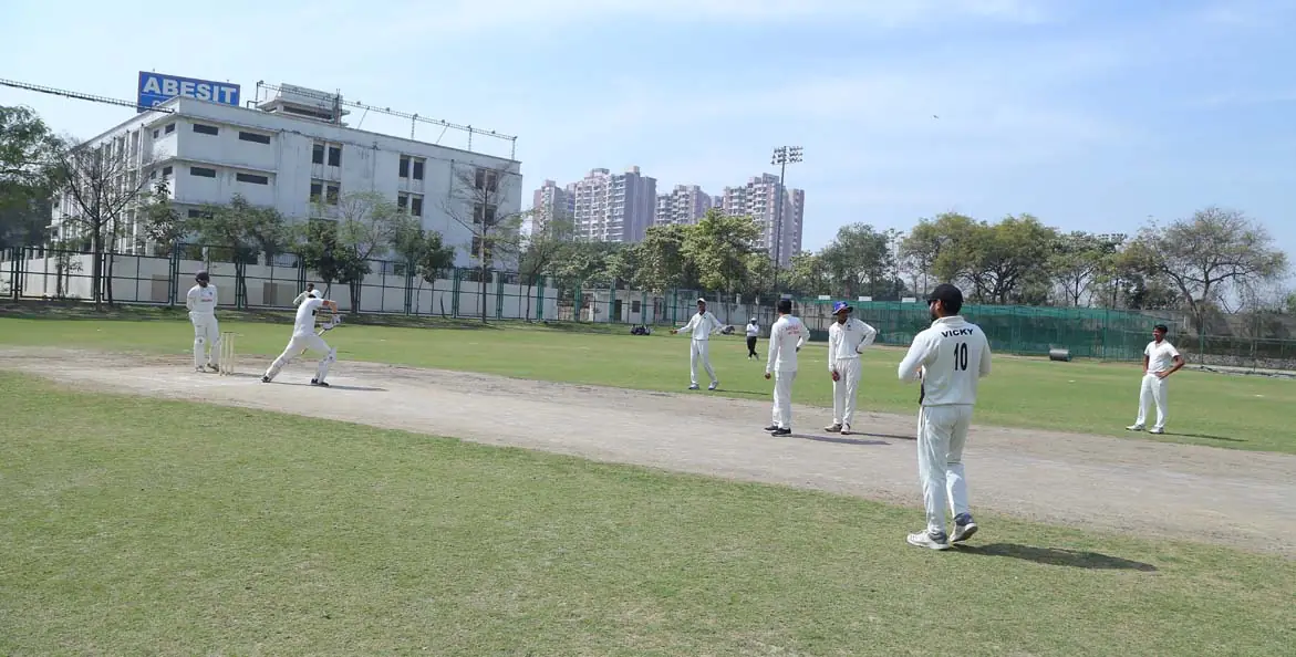 Cricket ground with campus buildings behind