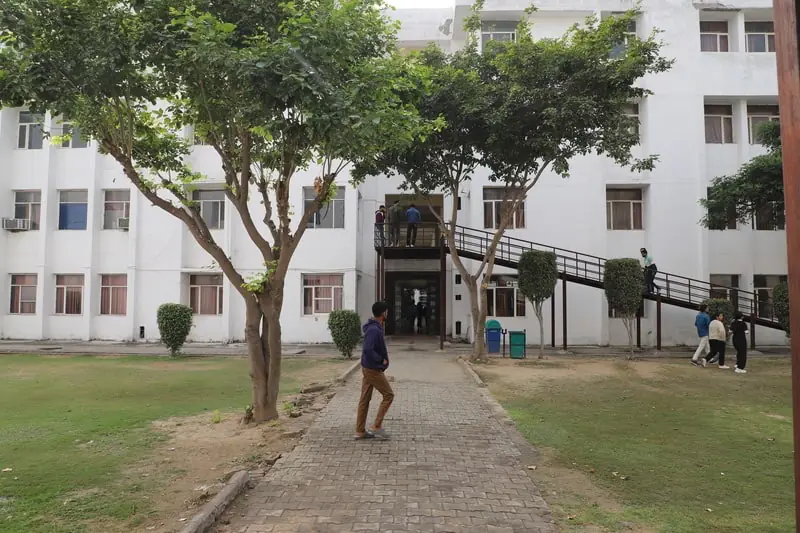 Academic block entrance with tree-lined walkway