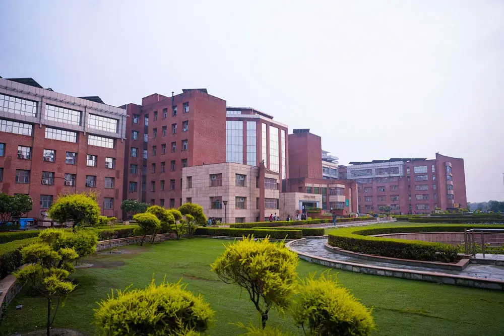 Red-brick academic blocks around a landscaped lawn