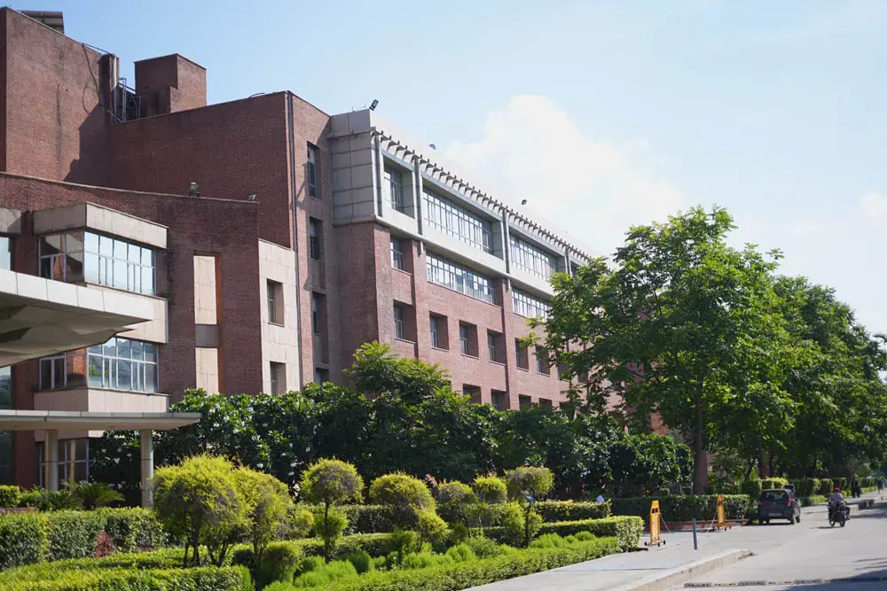 Academic building with gardens along the campus road