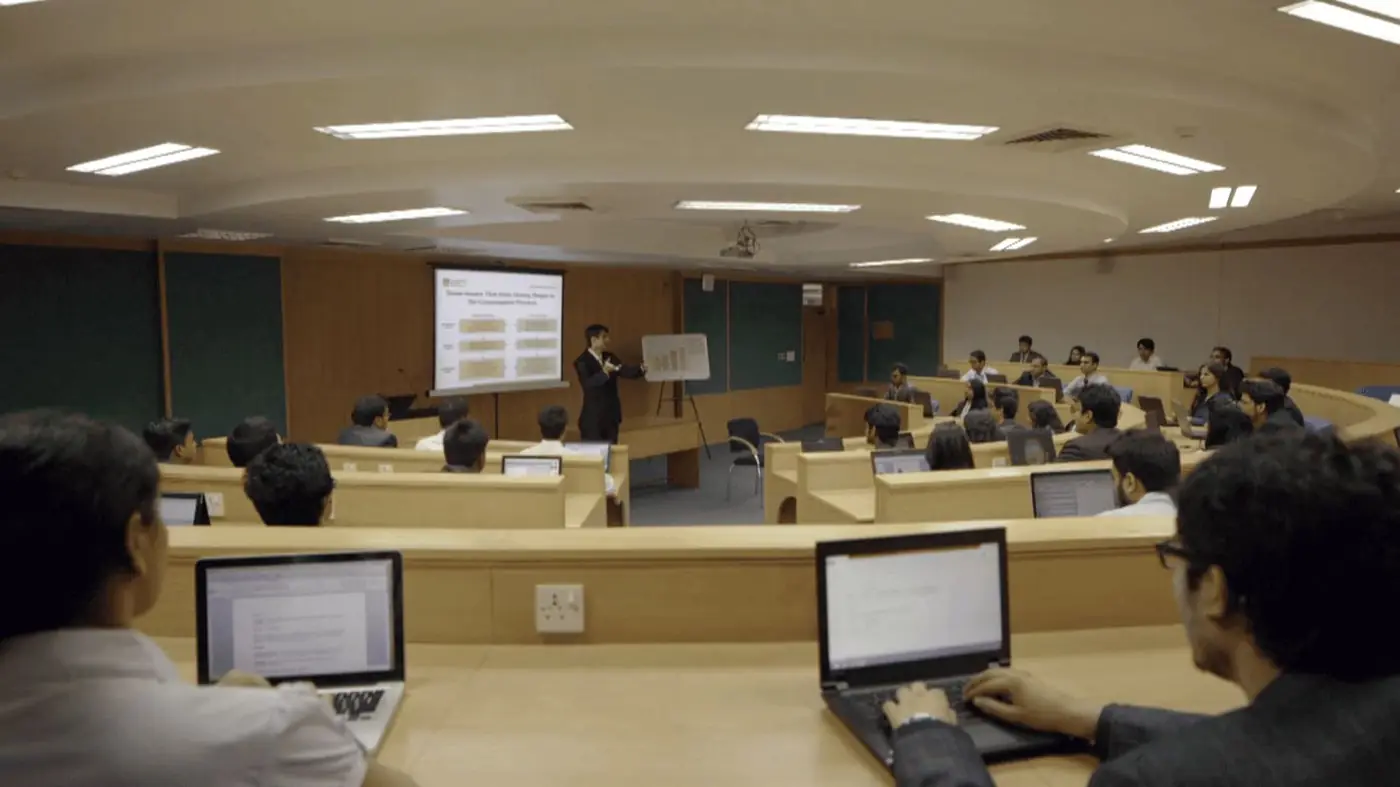 Amphitheatre-style classroom with students at laptops