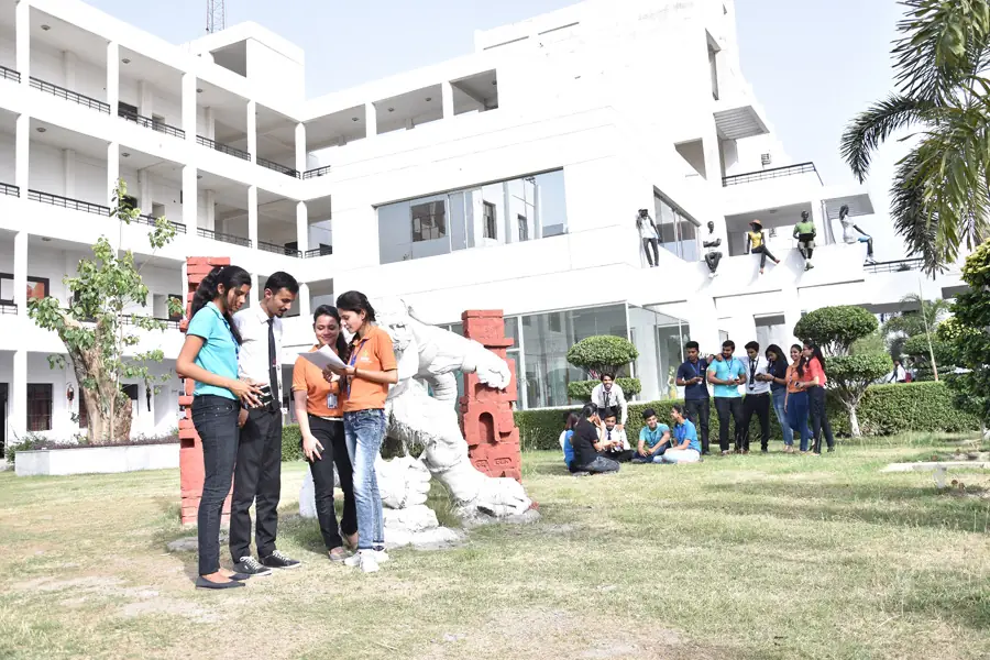 Students on the campus lawn beside a building