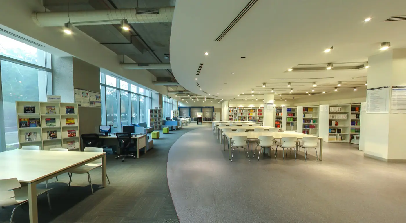 Central library with reading tables and glass facade