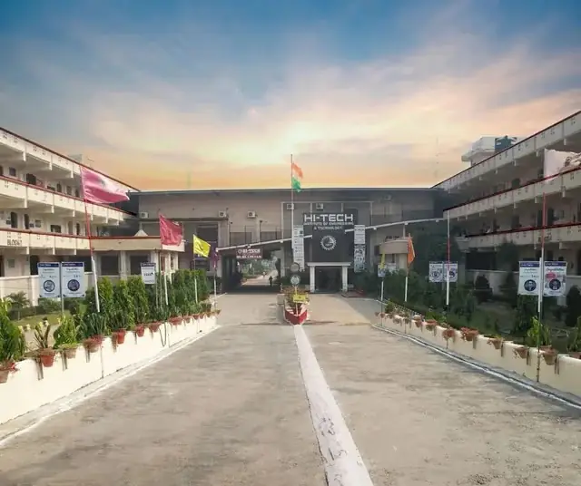 Main entrance driveway with flagpole and campus blocks