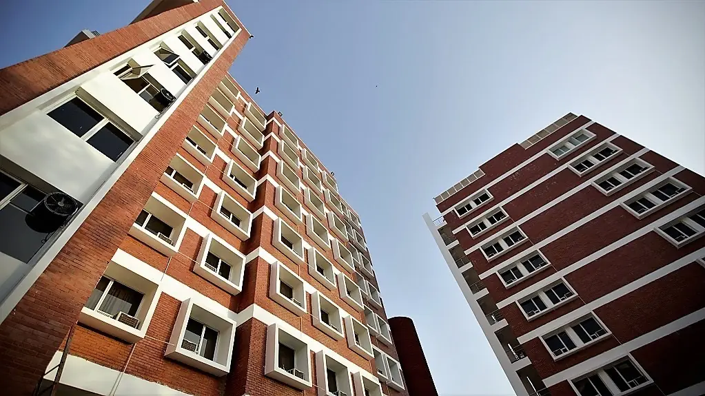 Red-brick residential towers, low-angle view