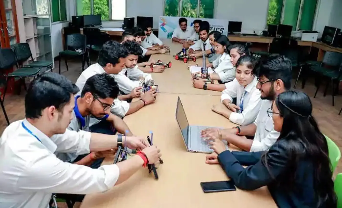 Robotics lab session around a shared workbench