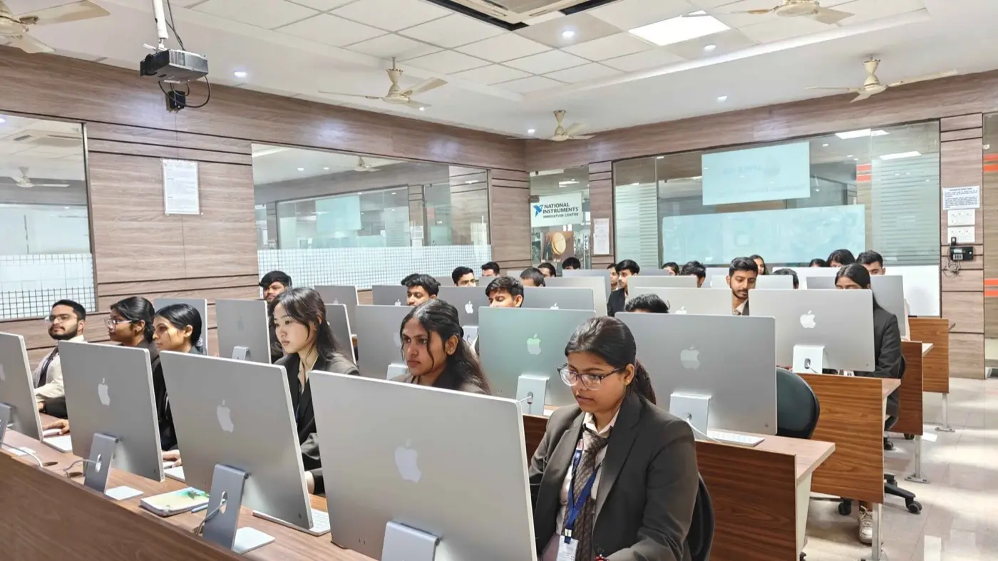 Computer lab with rows of iMac workstations