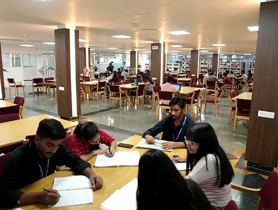 Library study hall with students reading at tables