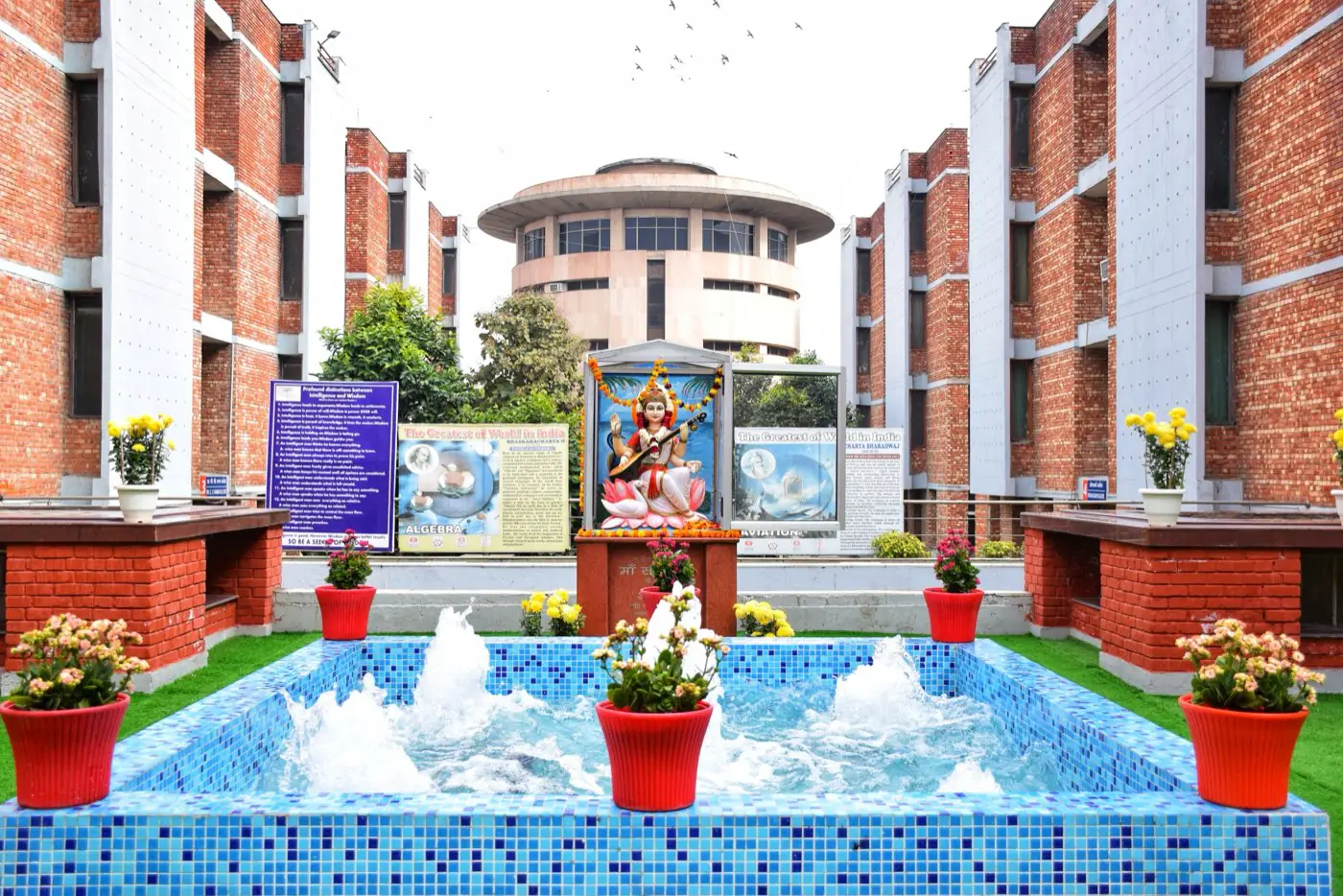 Inner courtyard fountain between red-brick blocks
