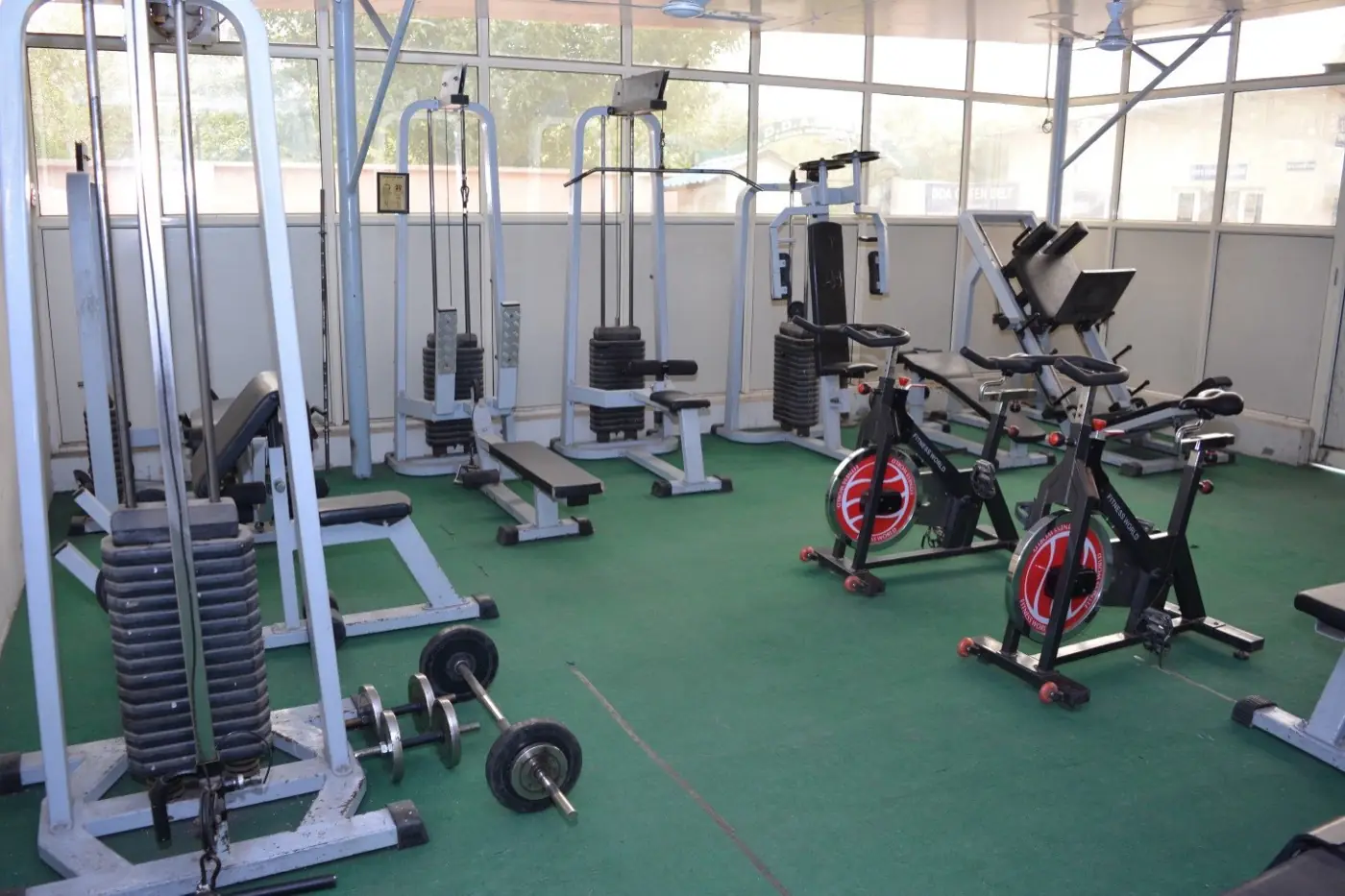 Campus gym with weight machines and exercise bikes