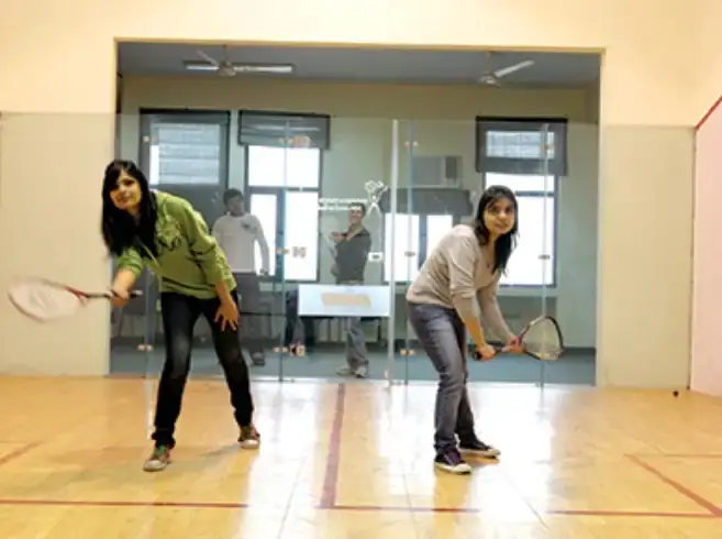 Indoor squash court with players