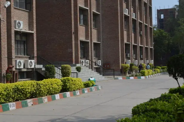 Academic block with entrance steps and hedges