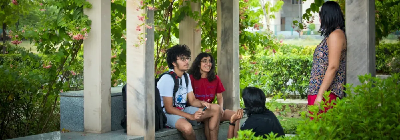 Students in a garden pergola near the residences
